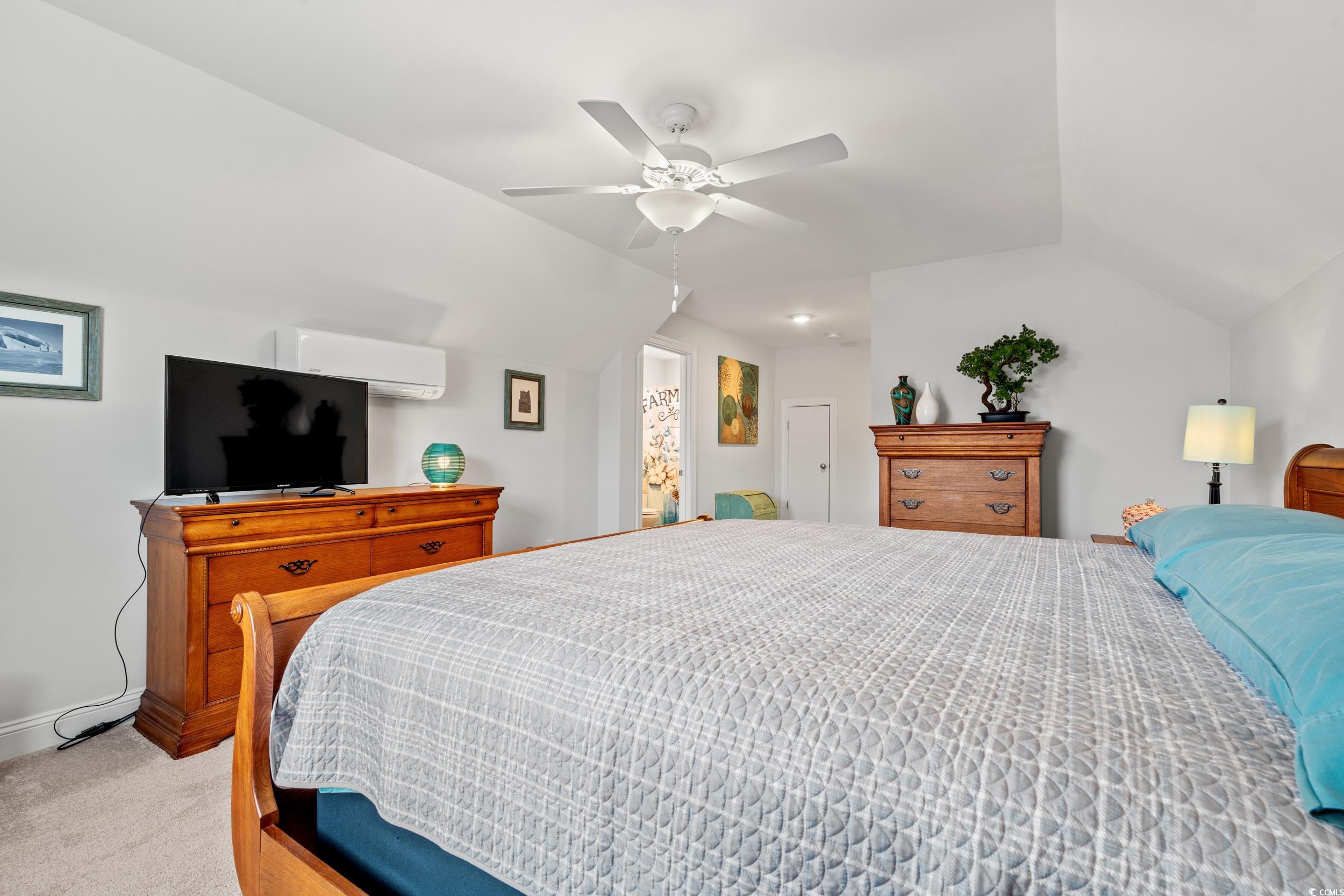 641 Indigo Bay Circle Myrtle Beach, SC 29579 - Photo 28 of 39 Carpeted bedroom featuring vaulted ceiling, a wall