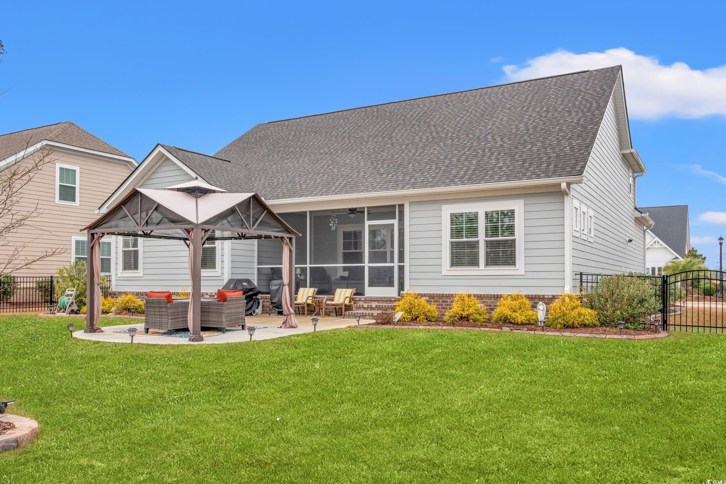 641 Indigo Bay Circle Myrtle Beach, SC 29579 - Photo 32 of 39 Back of property with an outdoor living space, a l