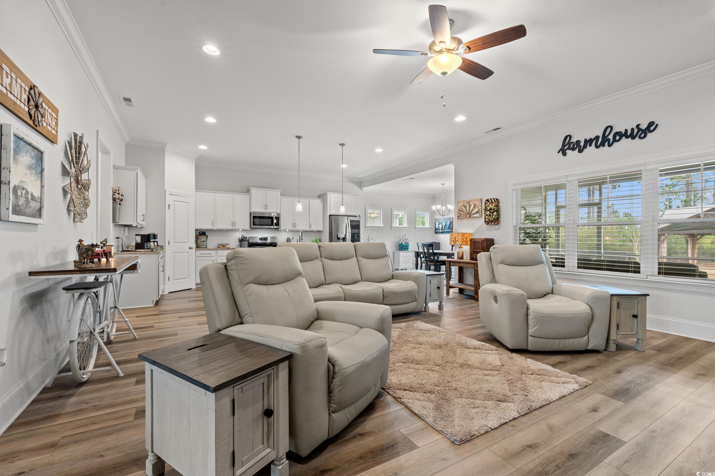 641 Indigo Bay Circle Myrtle Beach, SC 29579 - Photo 5 of 39 Living room with ornamental molding, ceiling fan w
