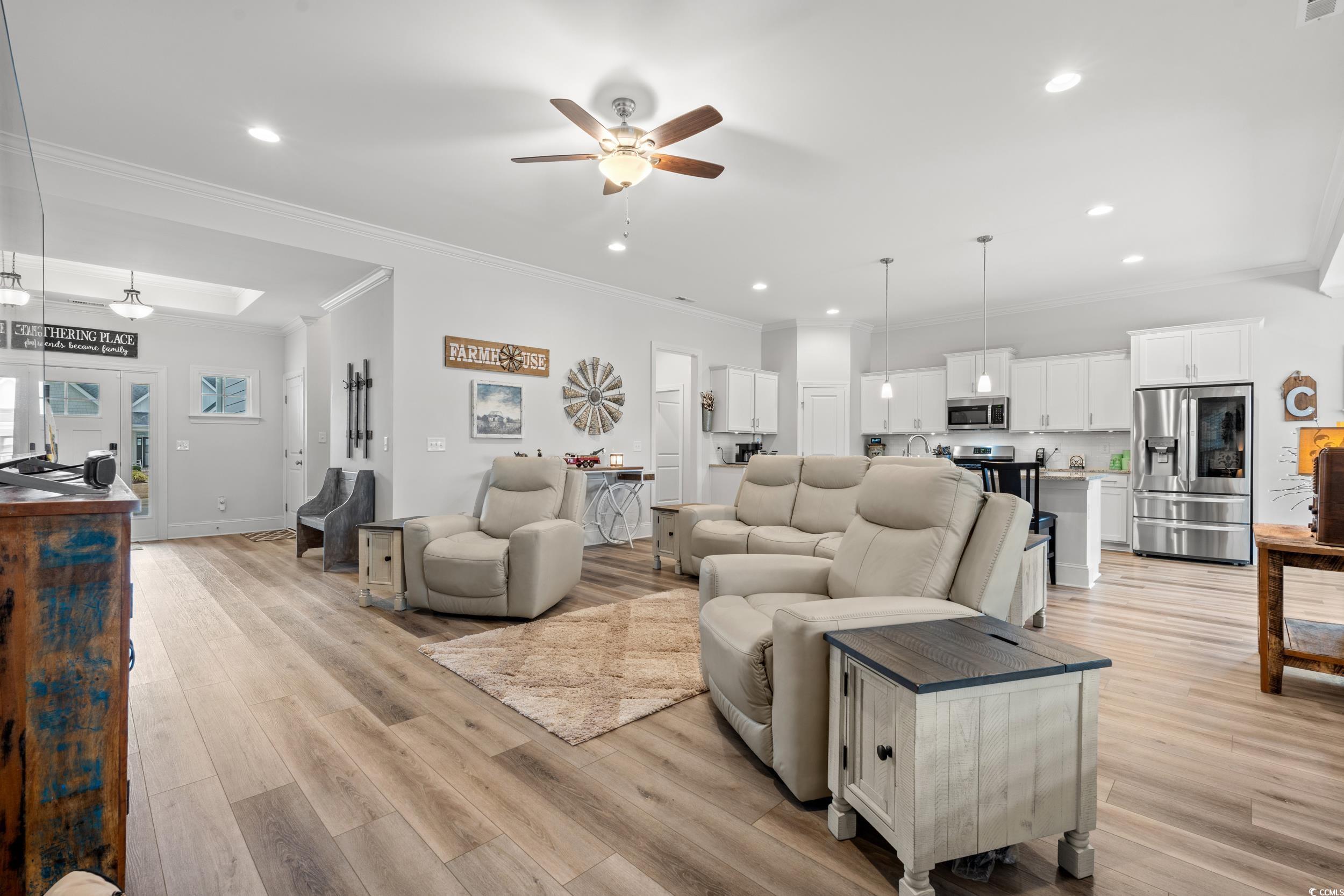 641 Indigo Bay Circle Myrtle Beach, SC 29579 - Photo 6 of 39 Living room with crown molding, a skylight, light