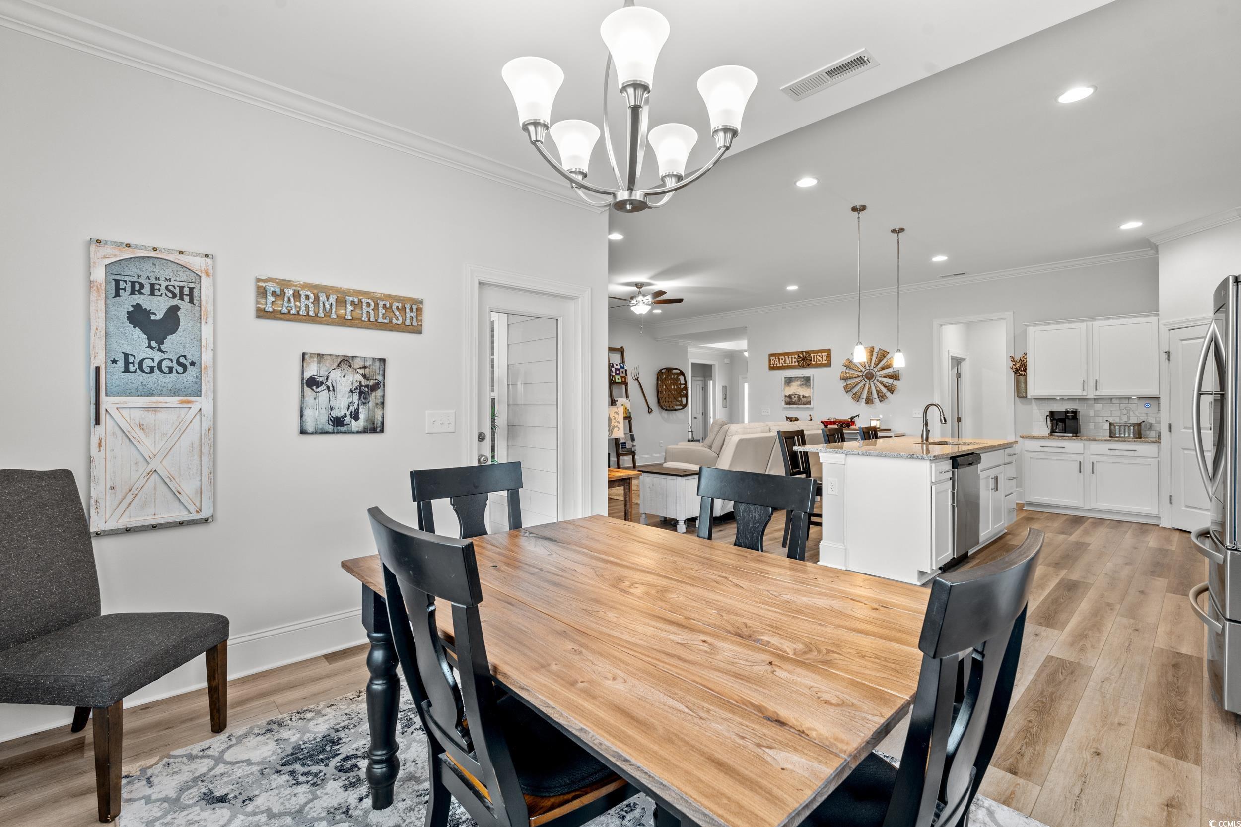 641 Indigo Bay Circle Myrtle Beach, SC 29579 - Photo 9 of 39 Dining room with crown molding, sink, ceiling fan