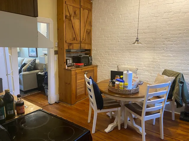 a dining room with furniture and wooden floor