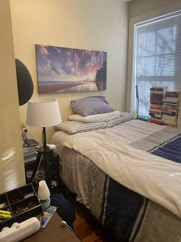 a bedroom with a bed and window