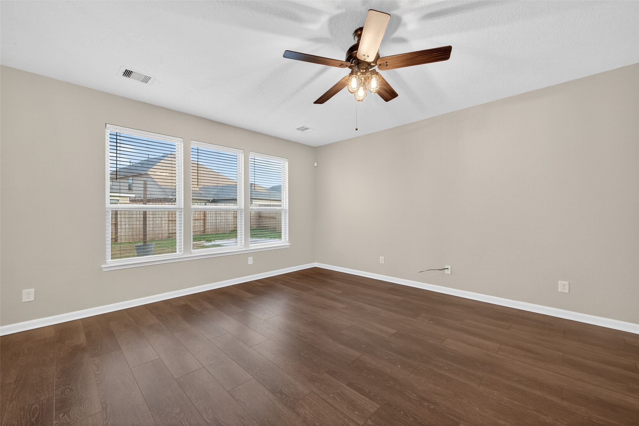 25403 King Reyes Street Katy, TX 77493 - Photo 12 of 27 a view of a big room with wooden floor and windows