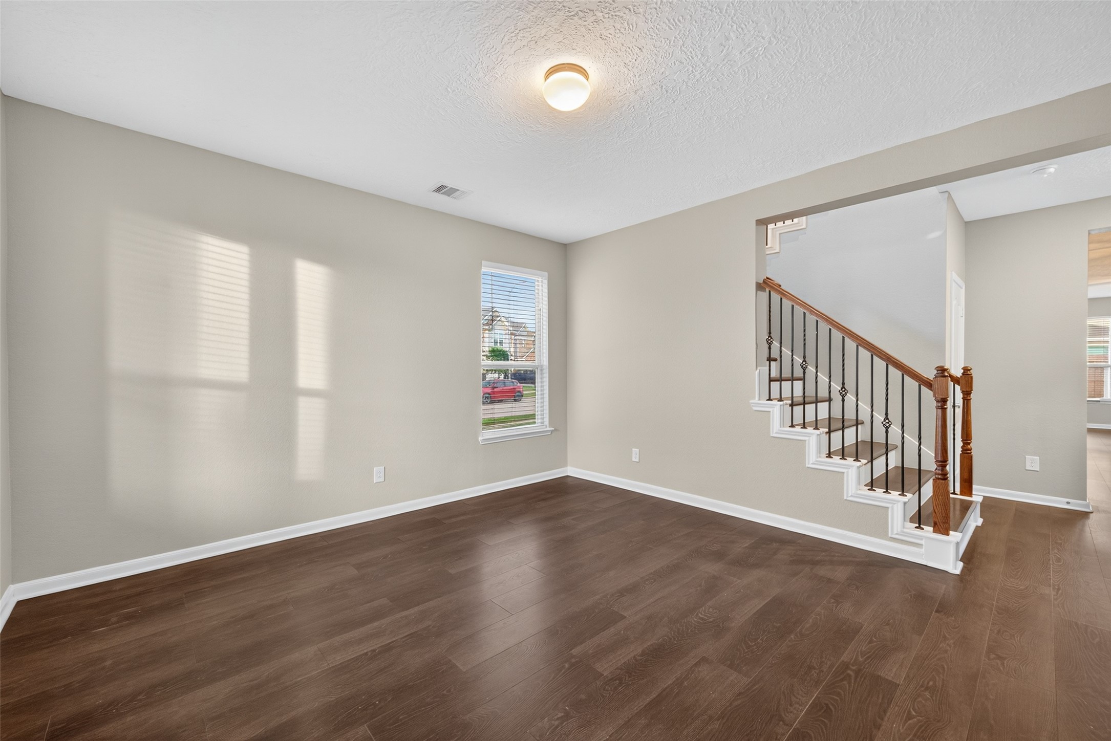 25403 King Reyes Street Katy, TX 77493 - Photo 15 of 27 a view of an empty room with wooden floor