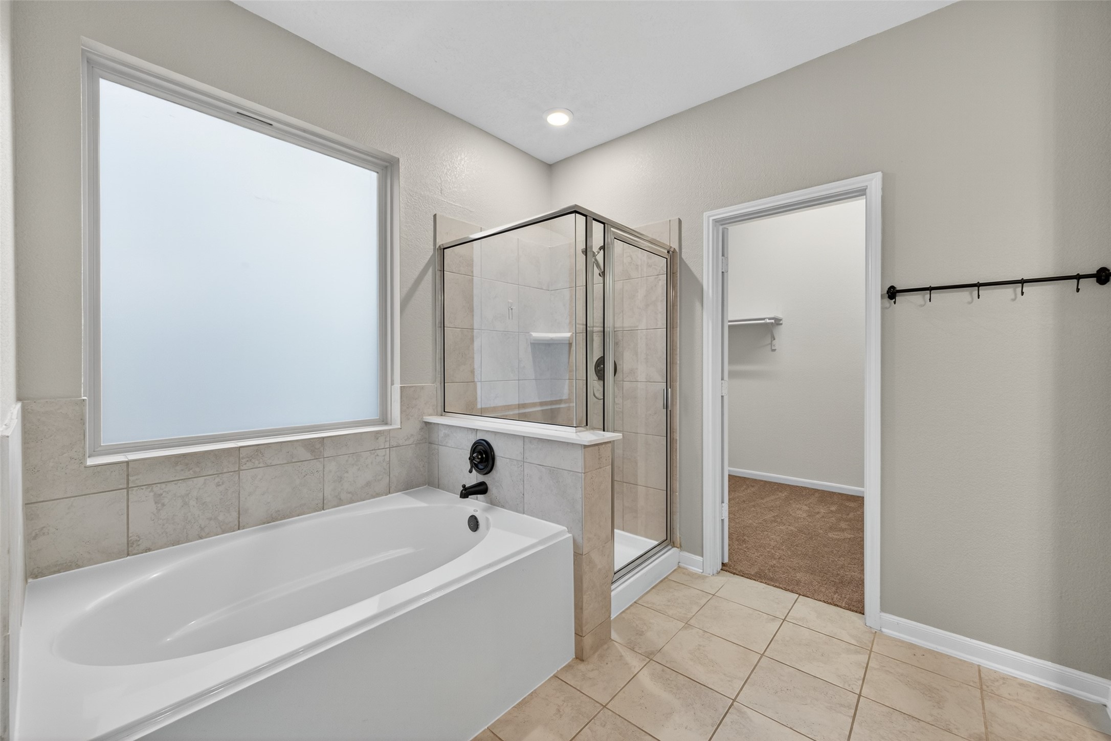 25403 King Reyes Street Katy, TX 77493 - Photo 19 of 27 a bathroom with a bathtub and a shower