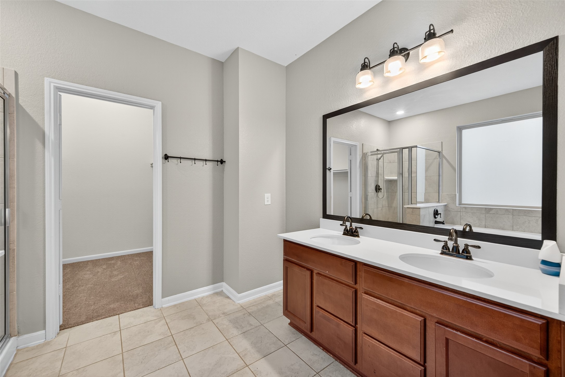 25403 King Reyes Street Katy, TX 77493 - Photo 20 of 27 a bathroom with a double vanity sink and a mirror