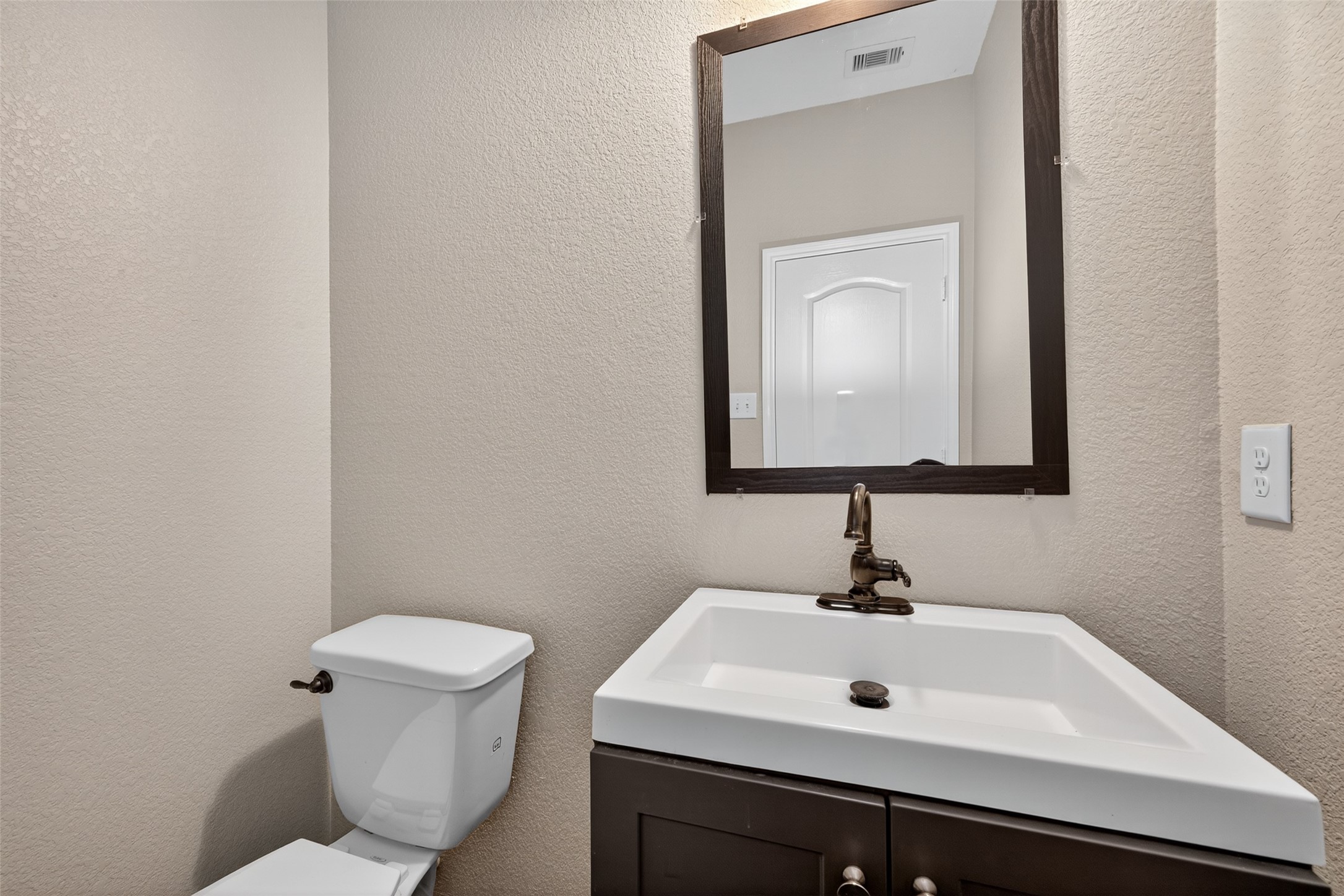 25403 King Reyes Street Katy, TX 77493 - Photo 26 of 27 a bathroom with a toilet sink and mirror
