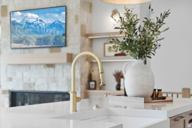 1400 Weber Wild Road Oakley, UT 84055 - Photo 14 of 55 Contemporary kitchen island featuring a white countertop with an integrated sink and a gold-tone faucet