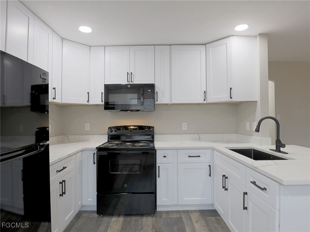 14181 Old Olga Road Fort Myers, FL 33905 - Photo 5 of 13 a kitchen with cabinets appliances a sink and a counter top