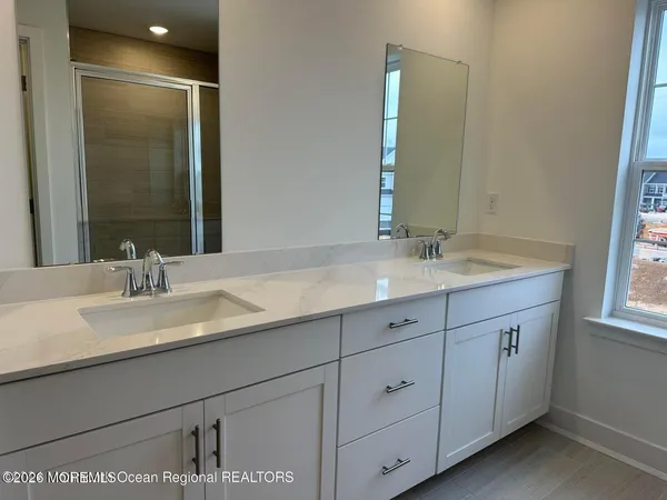 a bathroom with double sink and a mirror