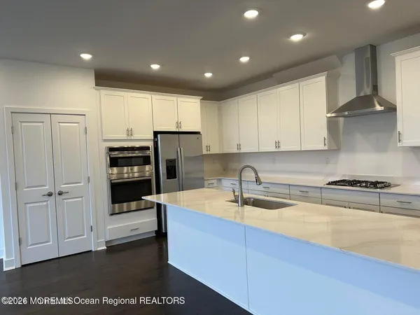a kitchen with a sink a stove and cabinets