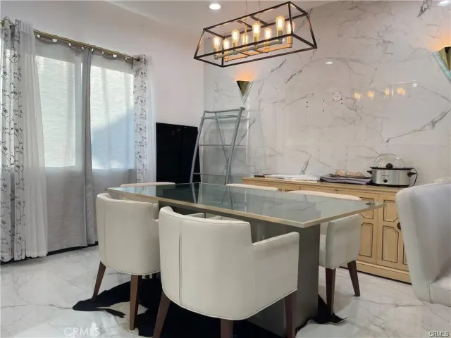 a kitchen with a table chairs and a refrigerator