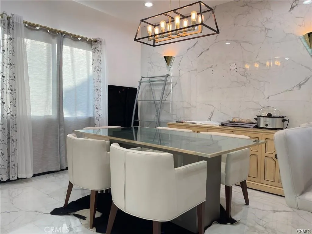 3823 Walnut Grove Avenue Rosemead, CA 91770 - Photo 3 of 28 a kitchen with a table chairs and a refrigerator