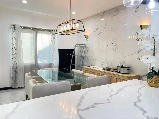 a kitchen with stainless steel appliances kitchen island a stove a sink and a refrigerator