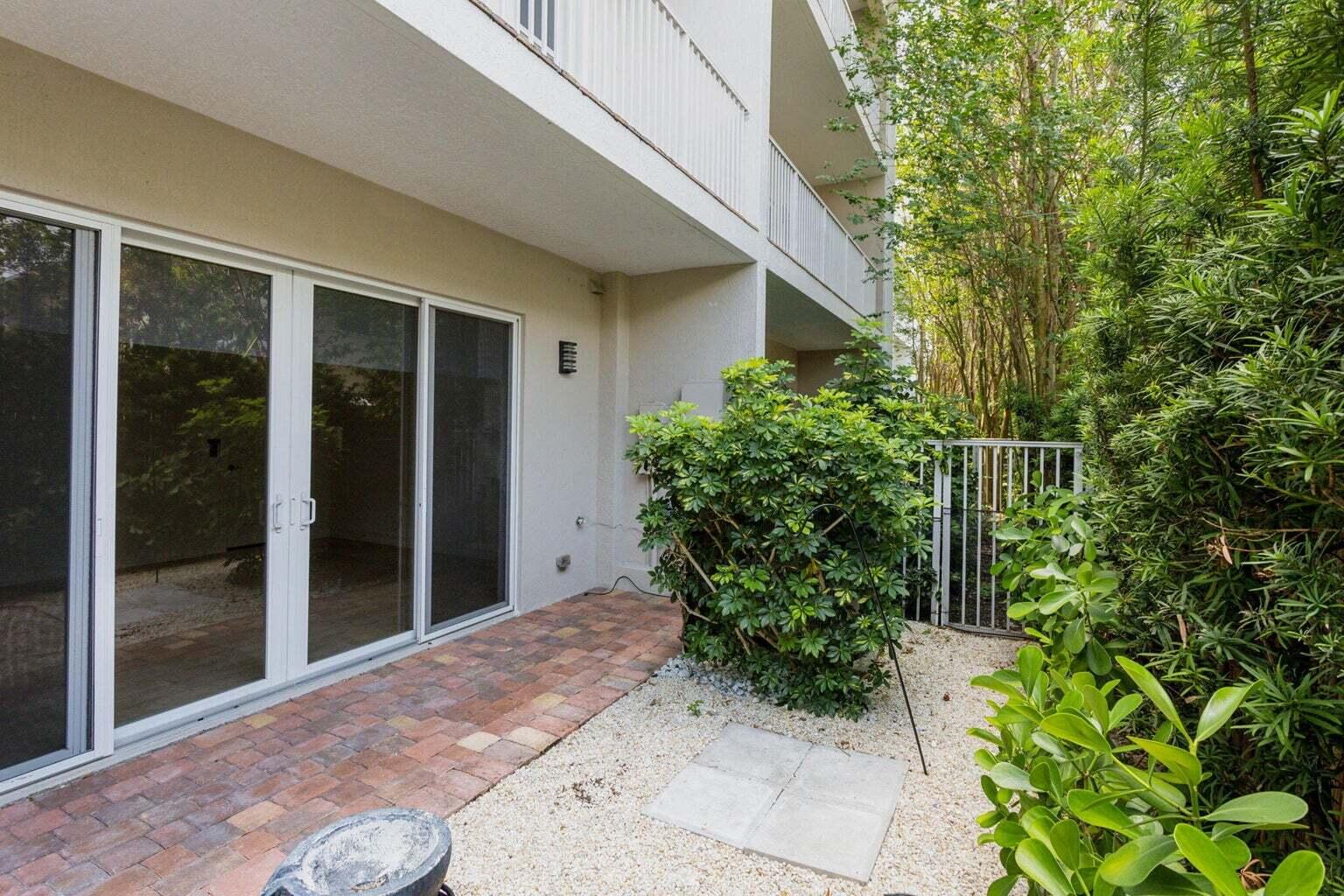 3873 Northeast 22nd Way Lighthouse Point, FL 33064 - Photo 15 of 43 a view of backyard with potted plants and floor to ceiling window