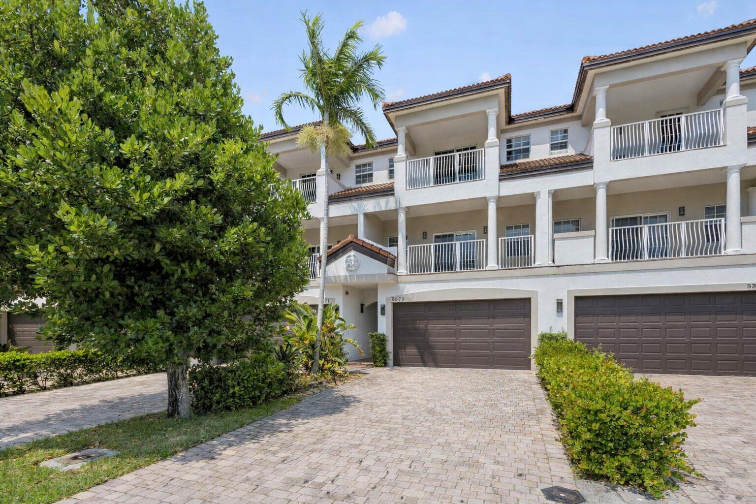 3873 Northeast 22nd Way Lighthouse Point, FL 33064 - Photo 2 of 43 a front view of a house with garden