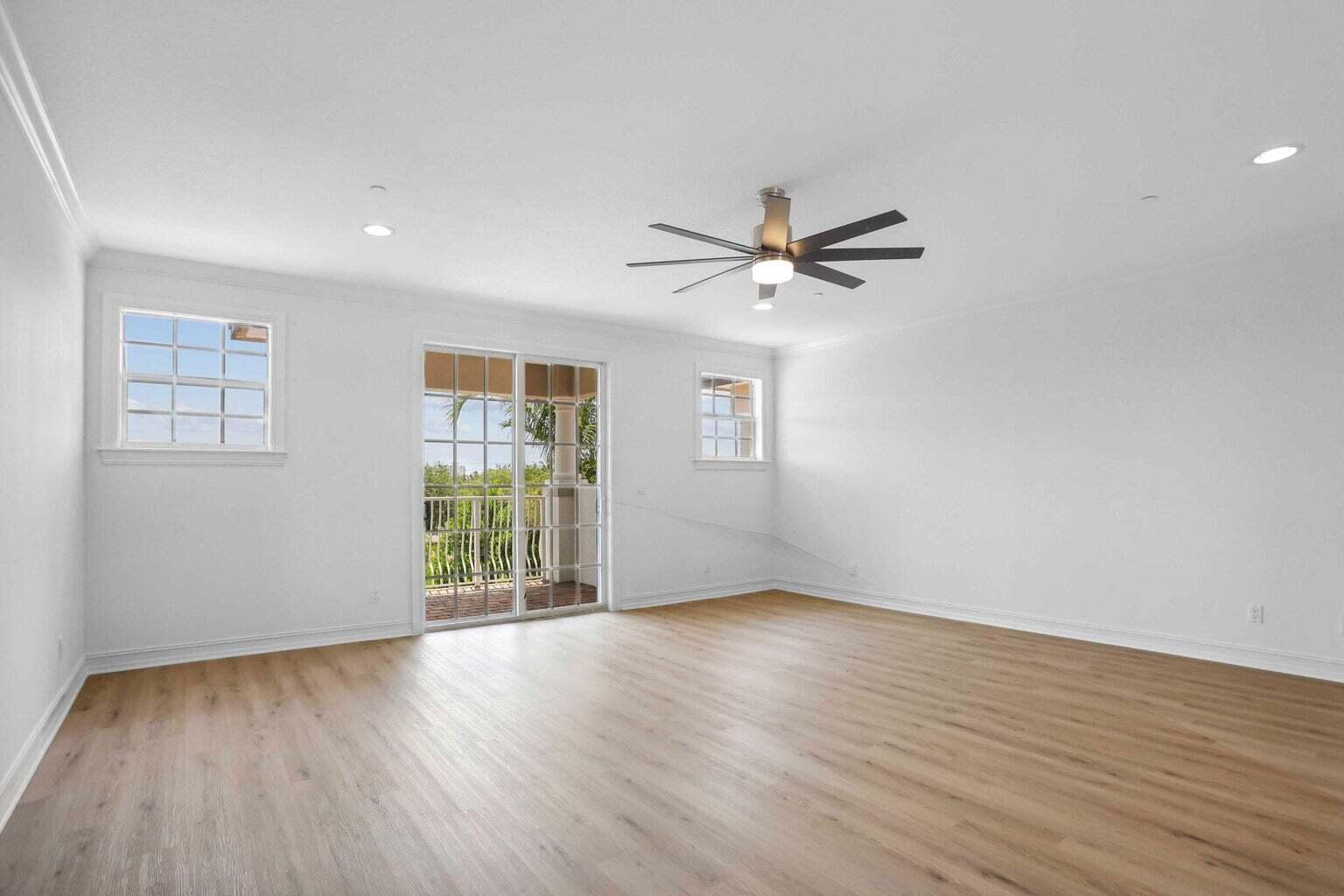 3873 Northeast 22nd Way Lighthouse Point, FL 33064 - Photo 23 of 43 an empty room with wooden floor and windows