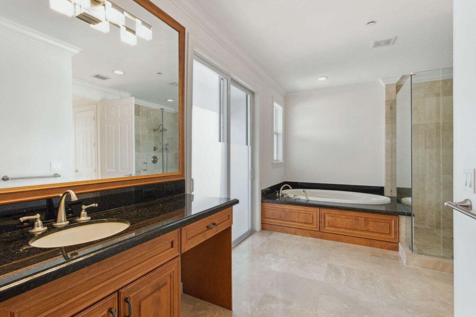 3873 Northeast 22nd Way Lighthouse Point, FL 33064 - Photo 39 of 43 a bathroom with a sink and a mirror