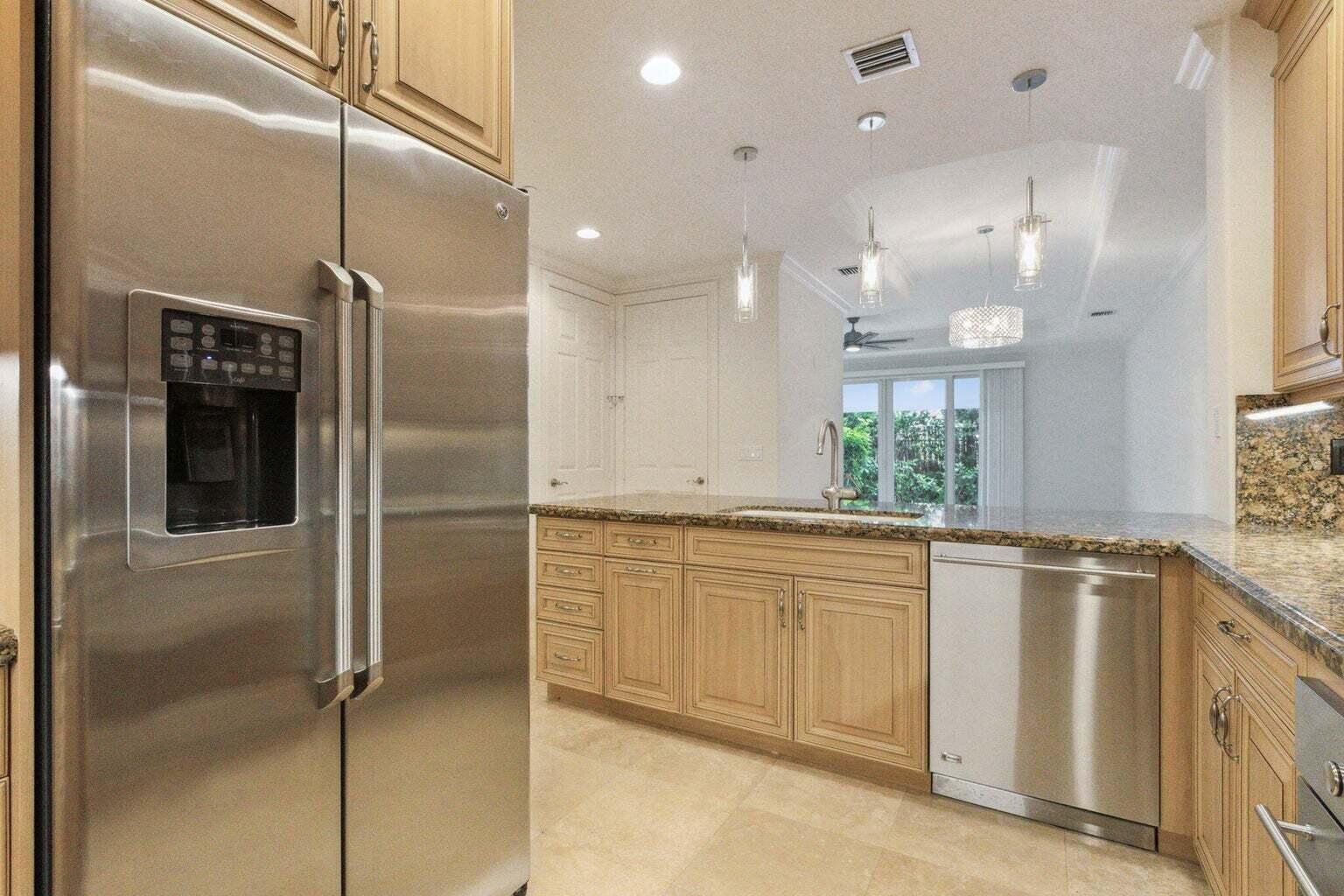 3873 Northeast 22nd Way Lighthouse Point, FL 33064 - Photo 7 of 43 a kitchen with stainless steel appliances granite countertop a refrigerator and a sink