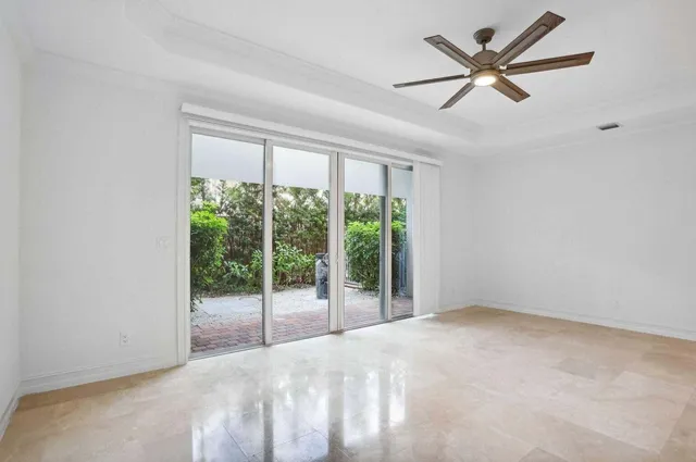 a view of a livingroom with a ceiling fan and a large window