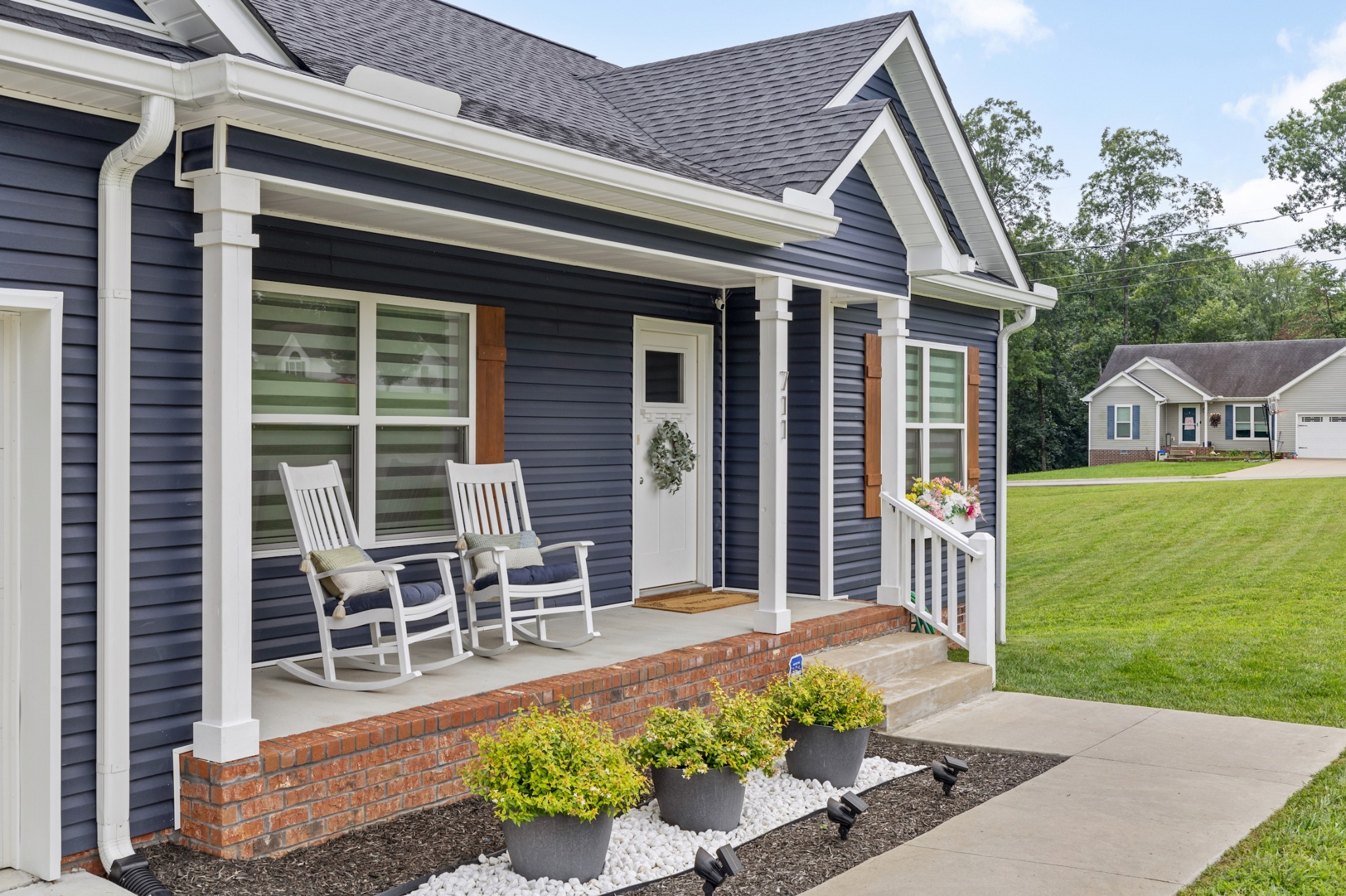 711 Ruby Way White Bluff, TN 37187 - Photo 2 of 24 a front view of a house with a garden and patio