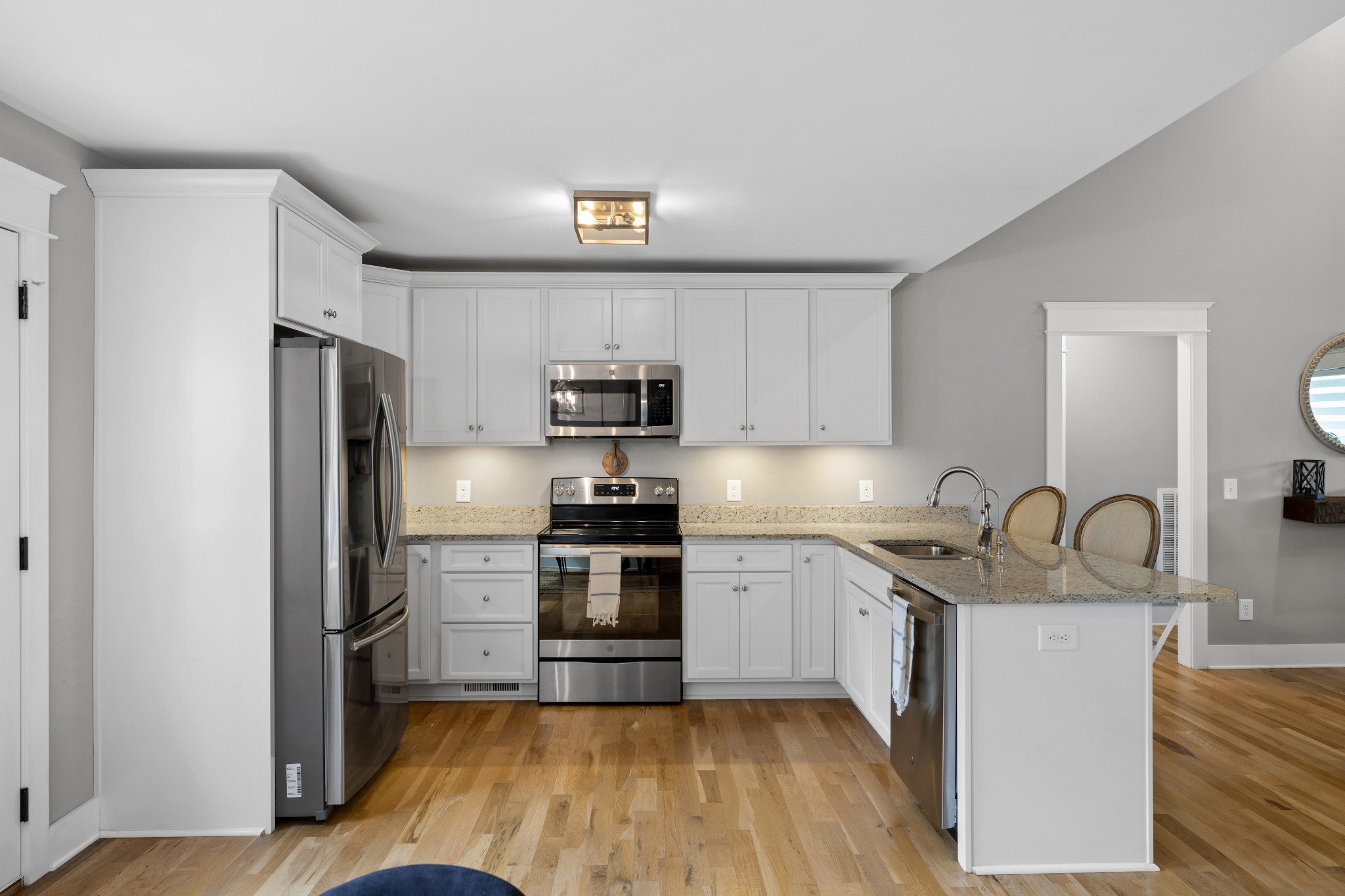 711 Ruby Way White Bluff, TN 37187 - Photo 6 of 24 a kitchen with stainless steel appliances granite countertop a sink stove refrigerator and cabinets