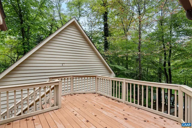 a view of wooden deck and a backyard