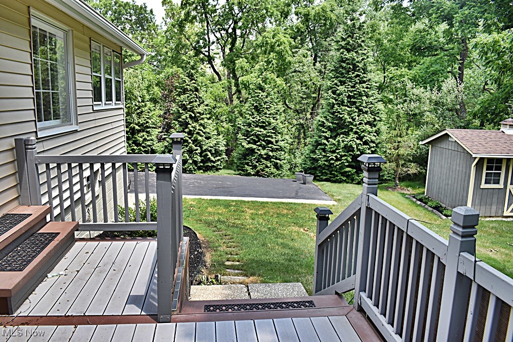17600 Egbert Road Bedford, OH 44146 - Photo 46 of 49 Composite deck featuring a storage shed and a lawn. Retractable awning covers the deck area for those hot sunny afternoons.