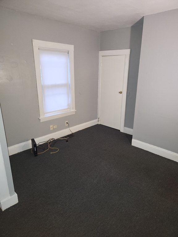 59 Banks Street, Unit 1 Brockton, MA 02302 - Photo 4 of 6 an empty room with a window