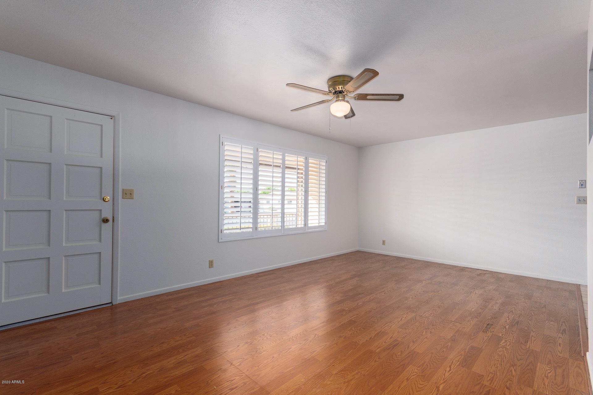 5704 East Decatur Street Mesa, AZ 85205 - Photo 8 of 40 a view of empty room with wooden floor and fan