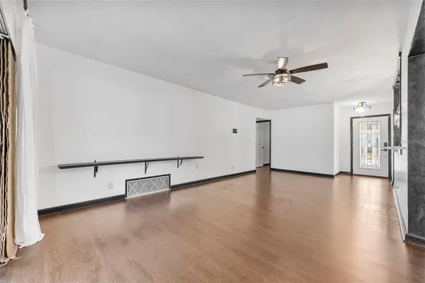 a view of an entryway with wooden floor