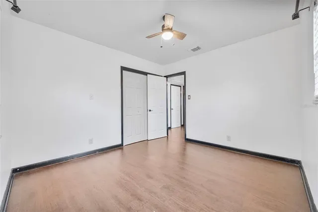 a view of a hallway with wooden floor