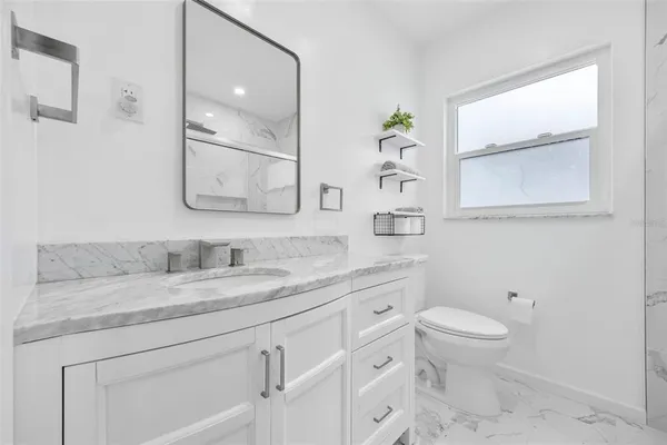 a bathroom with a shower sink and mirror