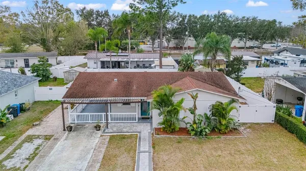 an aerial view of residential houses with outdoor space and lake view