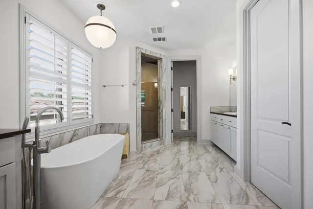 a spacious bedroom with a bed and a couch