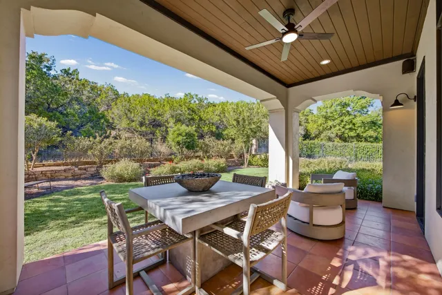 a bathroom with a granite countertop sink a toilet a mirror and shower
