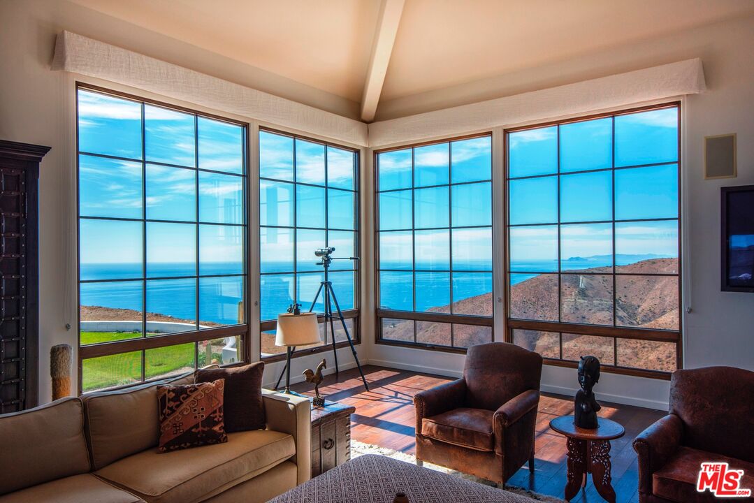 9785 Deer Creek Road Malibu, CA 90265 - Photo 11 of 75 a living room with furniture and a large window