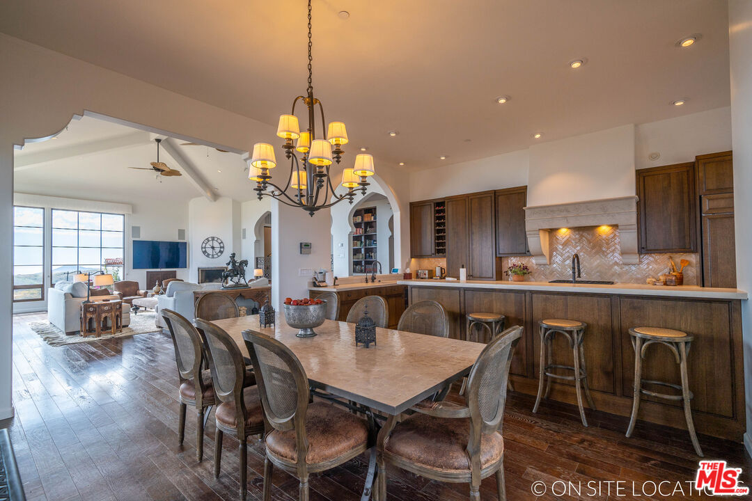 9785 Deer Creek Road Malibu, CA 90265 - Photo 15 of 75 a view of a dining room and livingroom with furniture a chandelier and wooden floor