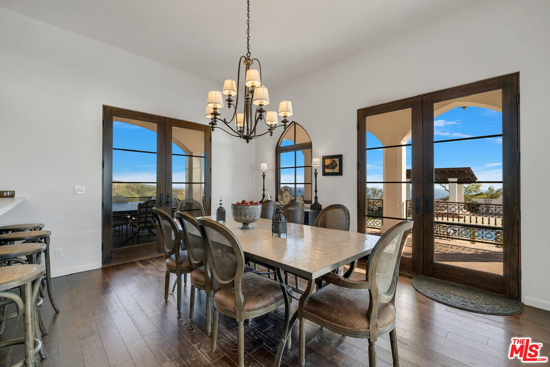 9785 Deer Creek Road Malibu, CA 90265 - Photo 17 of 75 a view of a dining room with furniture window and wooden floor
