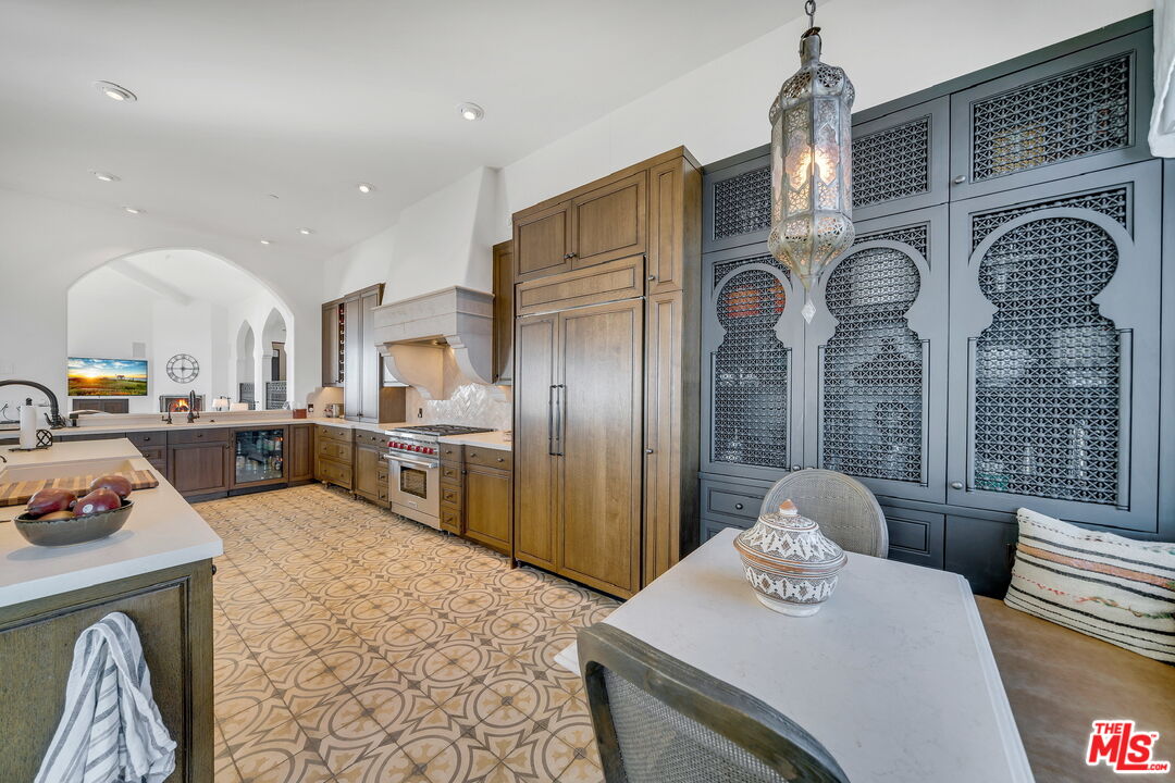 9785 Deer Creek Road Malibu, CA 90265 - Photo 18 of 75 a kitchen with stainless steel appliances granite countertop a sink a stove and refrigerator