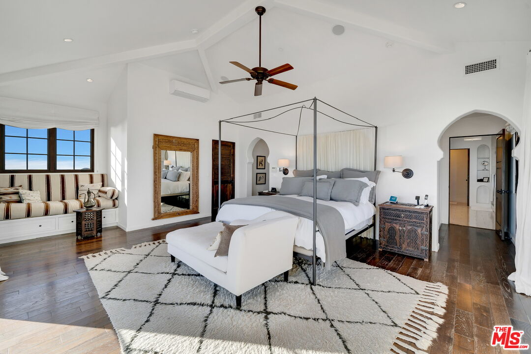 9785 Deer Creek Road Malibu, CA 90265 - Photo 25 of 75 a living room with furniture a chandelier and a rug