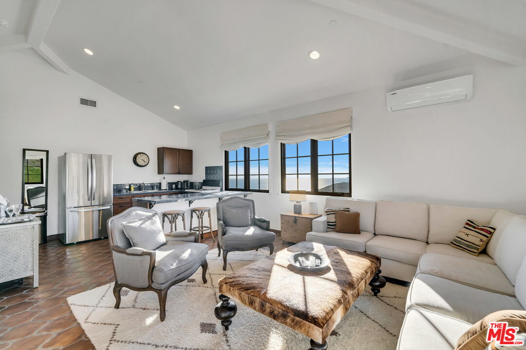 9785 Deer Creek Road Malibu, CA 90265 - Photo 31 of 75 a living room with furniture kitchen view and a window