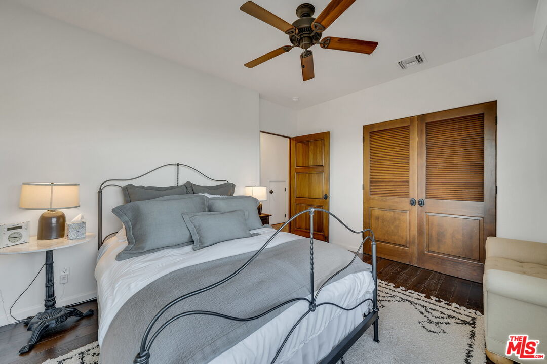 9785 Deer Creek Road Malibu, CA 90265 - Photo 34 of 75 a bedroom with a bed and a chandelier