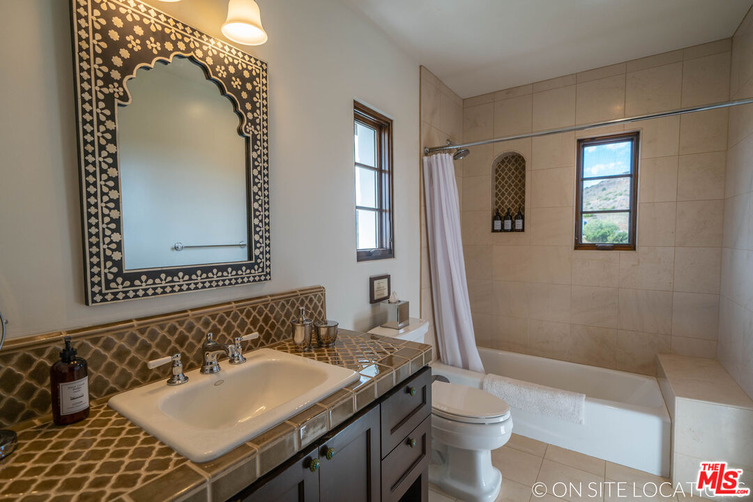 9785 Deer Creek Road Malibu, CA 90265 - Photo 41 of 75 a bathroom with a sink and a mirror