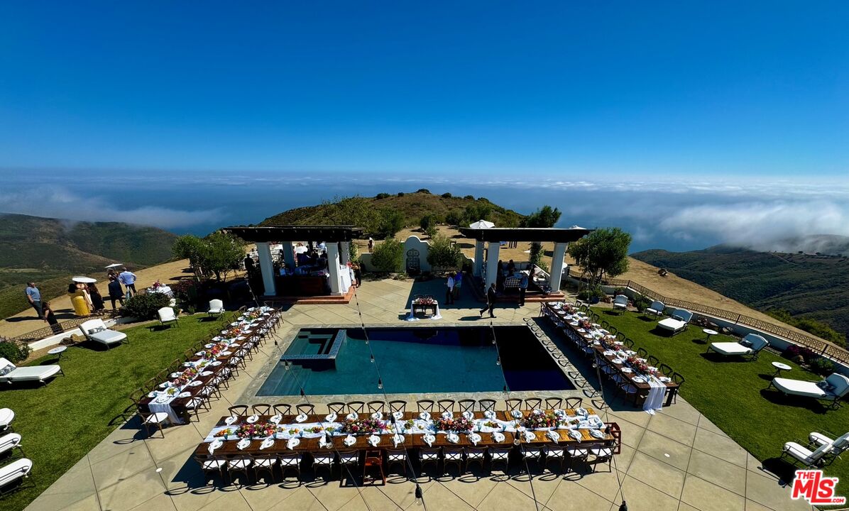 9785 Deer Creek Road Malibu, CA 90265 - Photo 48 of 75 a view of a chairs and table in a patio with swimming pool
