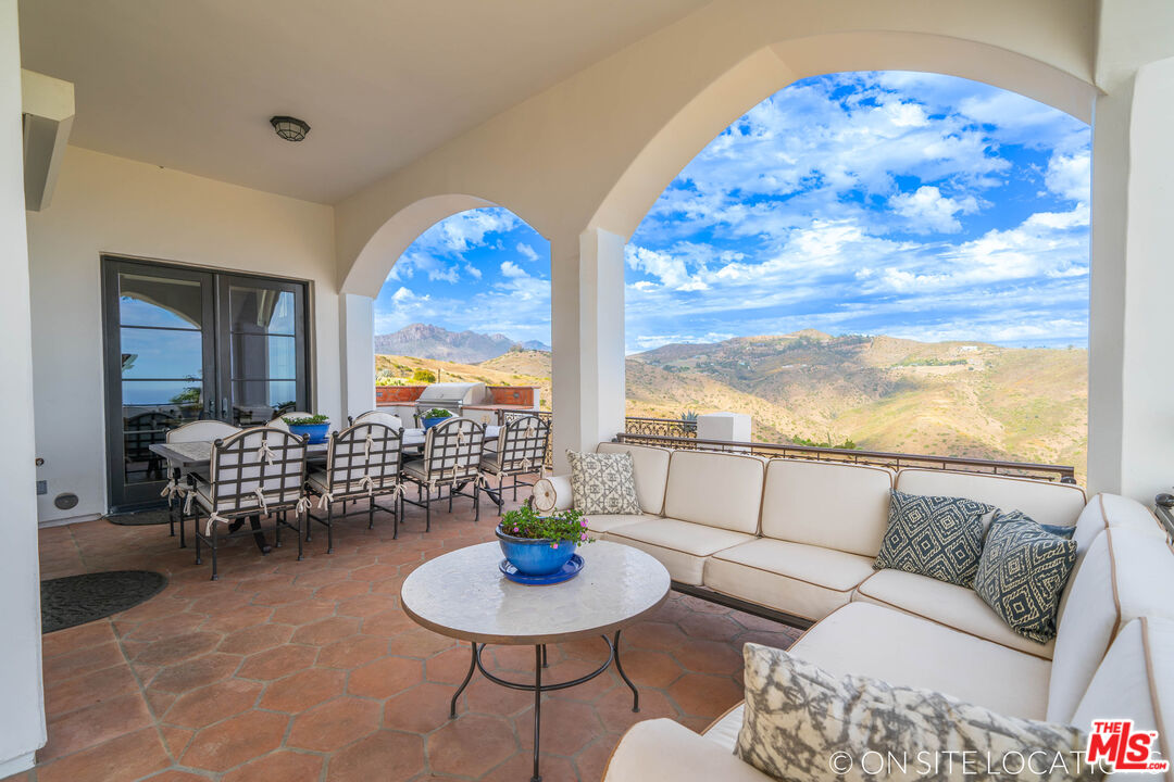 9785 Deer Creek Road Malibu, CA 90265 - Photo 51 of 75 a living room with furniture and a large window