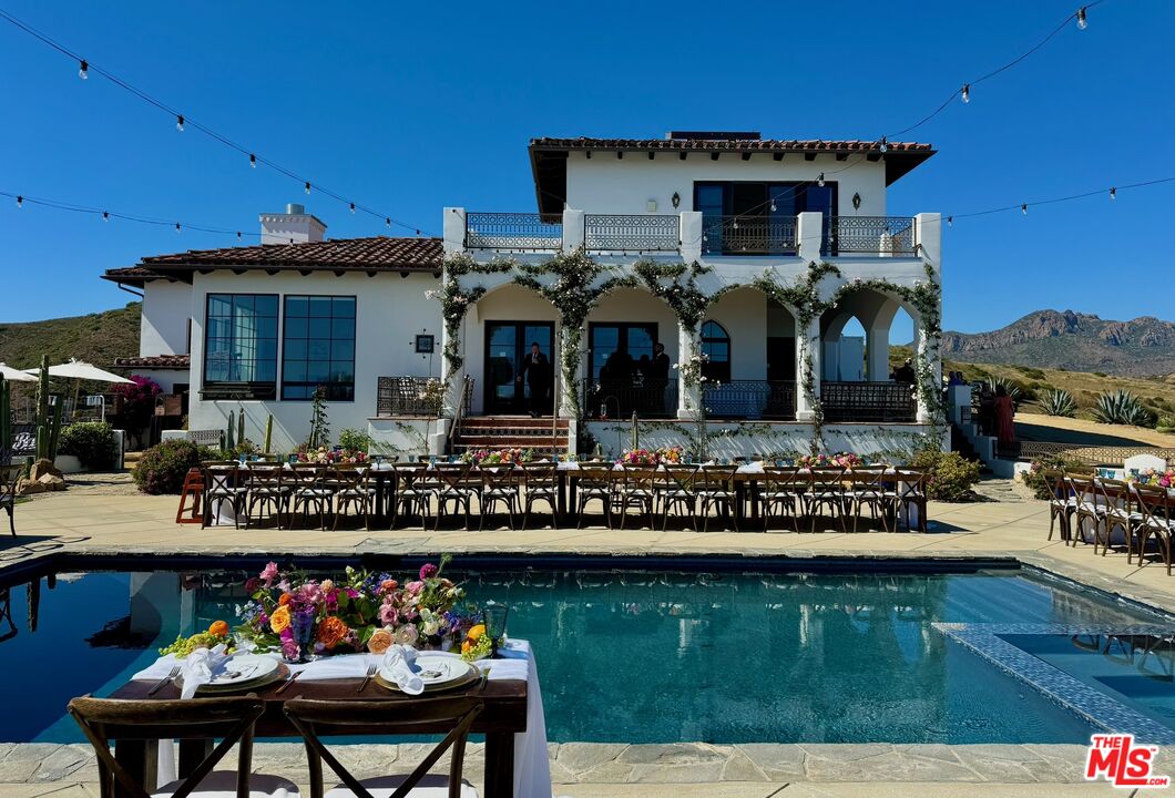9785 Deer Creek Road Malibu, CA 90265 - Photo 53 of 75 a front view of a house with swimming pool and outdoor seating
