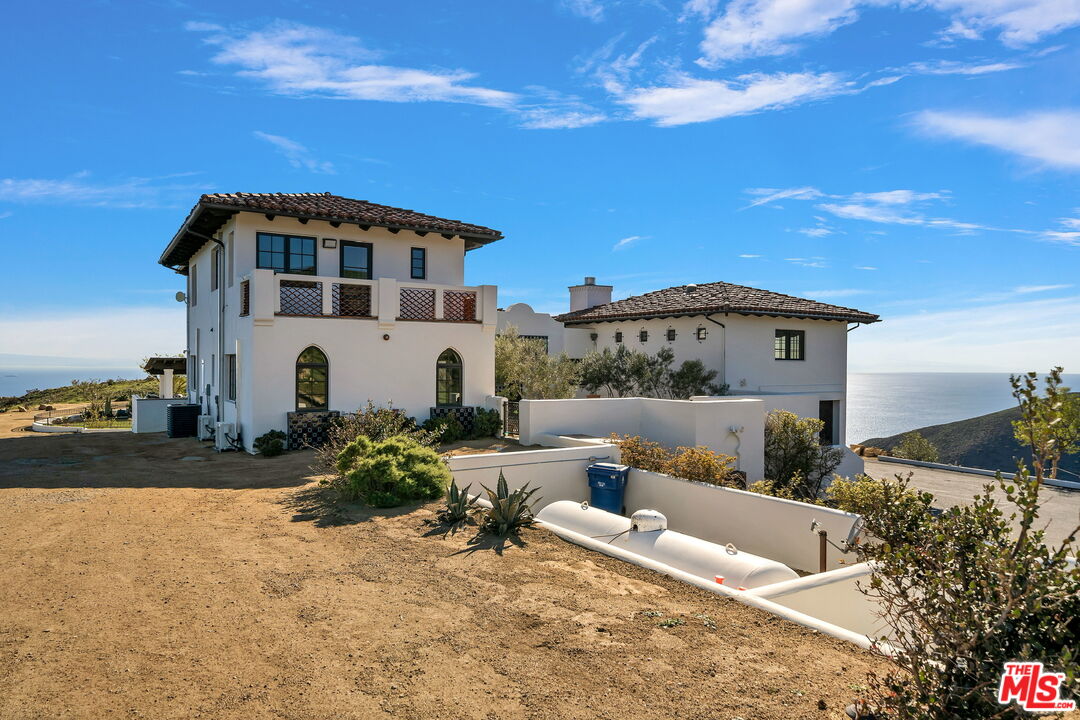 9785 Deer Creek Road Malibu, CA 90265 - Photo 6 of 75 a view of a white house with a yard