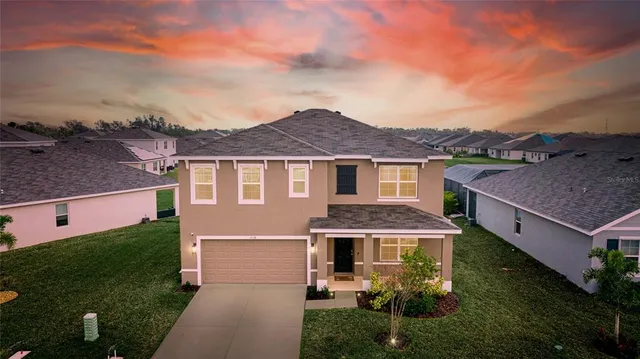 a aerial view of a house with a yard